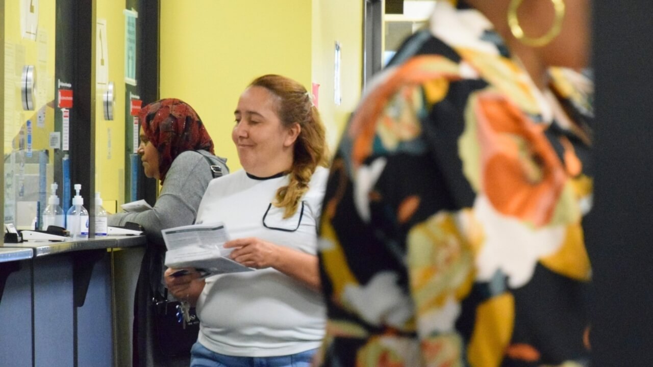 Person approaching the tax office window for customer service