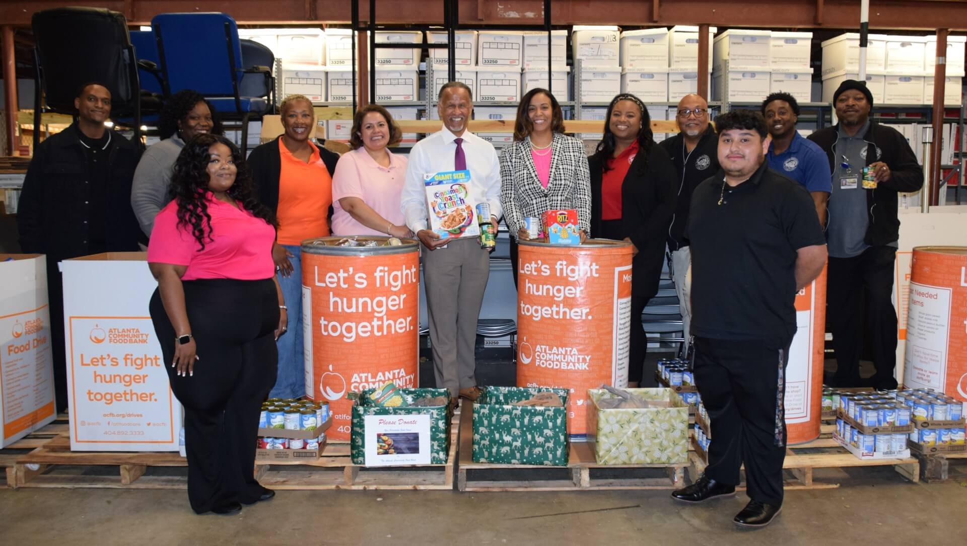 Standing center, DeKalb Tax Commissioner Irvin Johnson and Chief Deputy Tax Commissioner Nicole Golden surrounded by office staff during donation day.